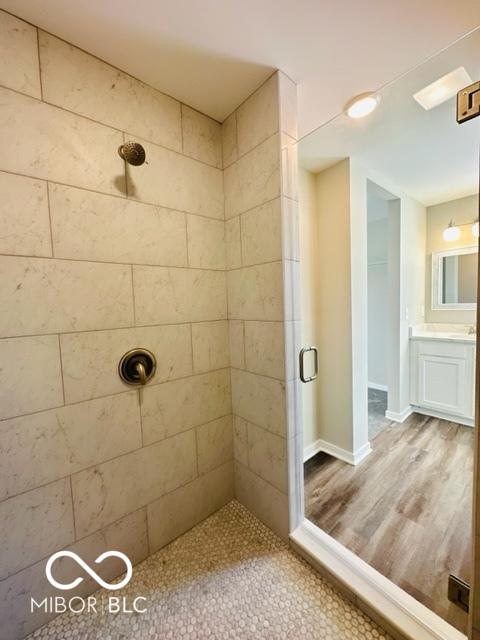 bathroom featuring vanity and a shower with door