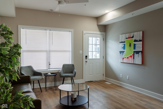 sitting room with ceiling fan and light hardwood / wood-style flooring