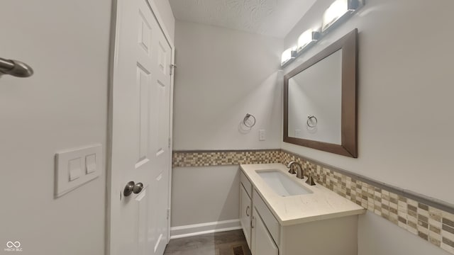 bathroom with vanity and a textured ceiling