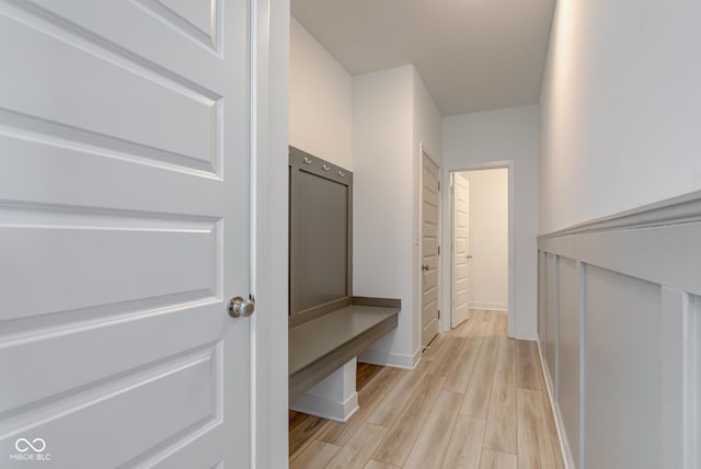 hallway with light hardwood / wood-style floors