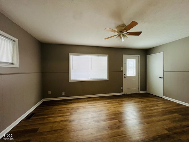 unfurnished room with dark hardwood / wood-style floors and ceiling fan