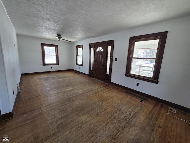 foyer featuring dark hardwood / wood-style flooring, a textured ceiling, and ceiling fan