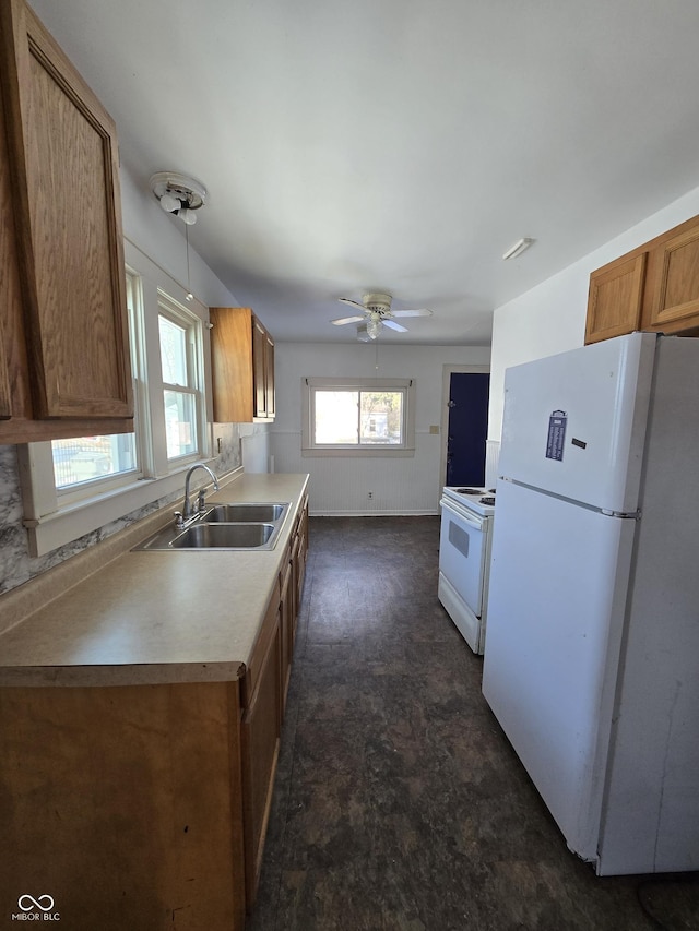 kitchen with ceiling fan, white appliances, decorative light fixtures, and sink