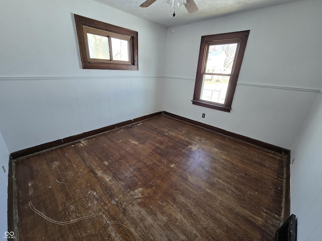 unfurnished room featuring ceiling fan and dark hardwood / wood-style flooring