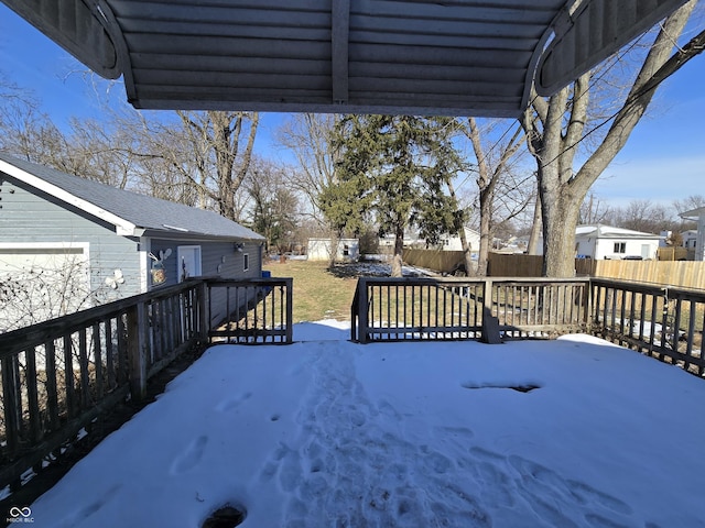 snow covered deck featuring a lawn