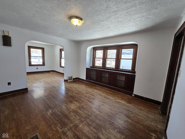 interior space with dark wood-type flooring and a textured ceiling