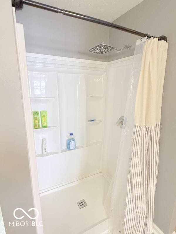 bathroom with a shower with shower curtain