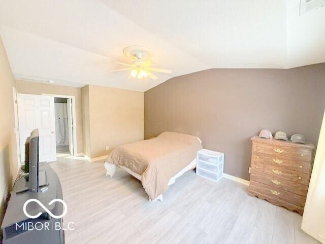 bedroom with ceiling fan, lofted ceiling, and light hardwood / wood-style floors