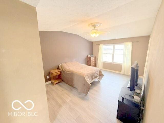 bedroom with lofted ceiling, light hardwood / wood-style flooring, and ceiling fan