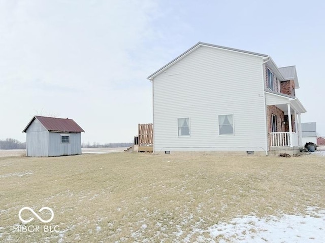 view of side of home with a storage unit