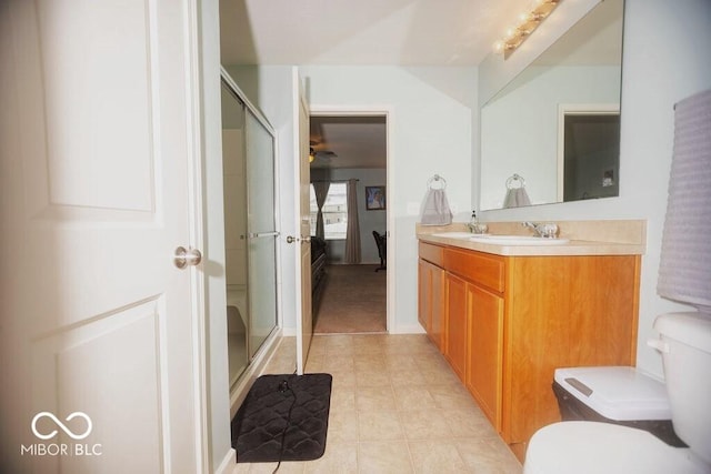 bathroom featuring vanity, toilet, and an enclosed shower