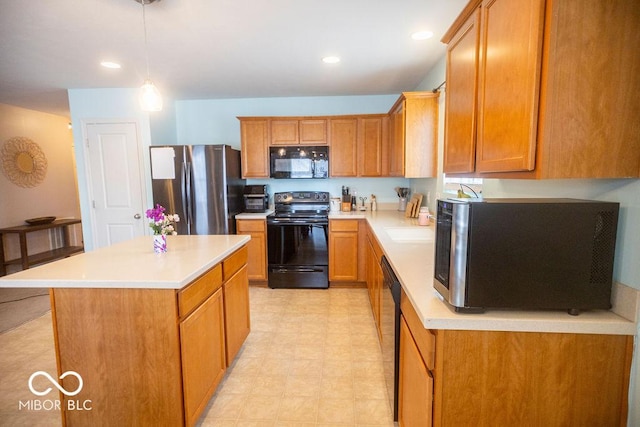 kitchen featuring a center island, pendant lighting, and black appliances