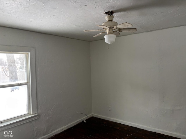 empty room featuring dark hardwood / wood-style floors and ceiling fan