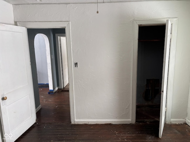 hallway featuring dark hardwood / wood-style flooring