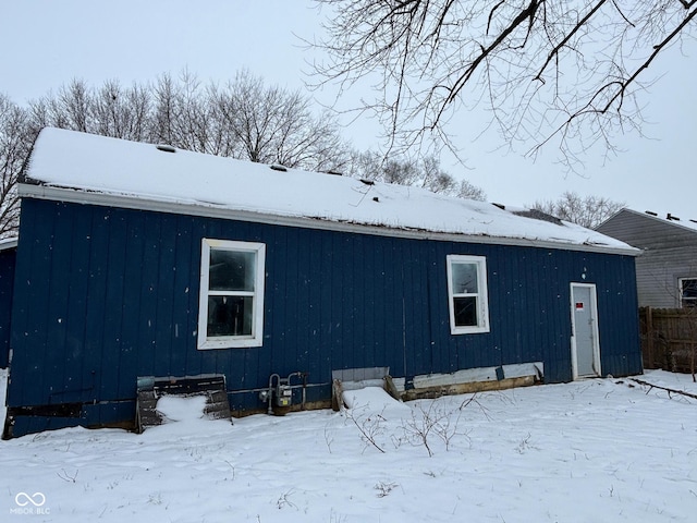 view of snow covered rear of property