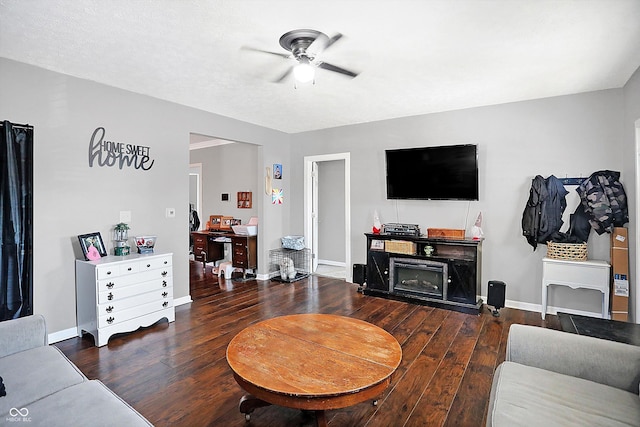 living room with dark hardwood / wood-style floors, a textured ceiling, and ceiling fan