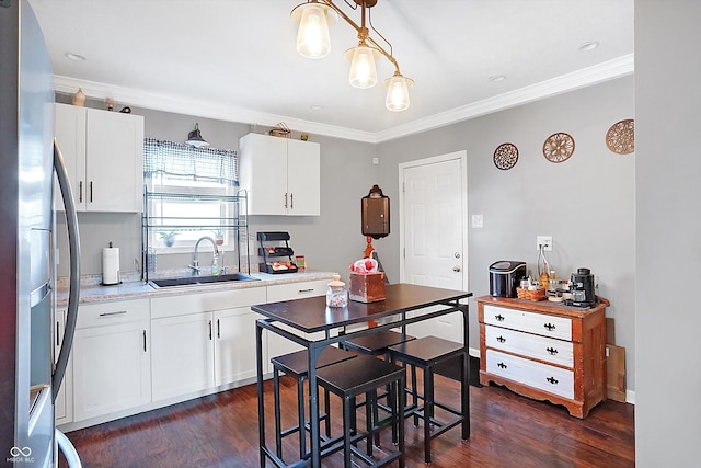 kitchen with white cabinetry, stainless steel fridge with ice dispenser, and sink