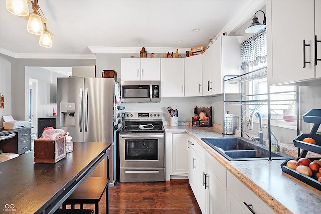 kitchen with sink, crown molding, dark wood-type flooring, white cabinetry, and stainless steel appliances