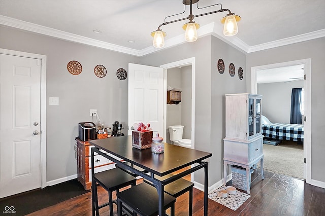 dining room with ornamental molding and dark hardwood / wood-style floors