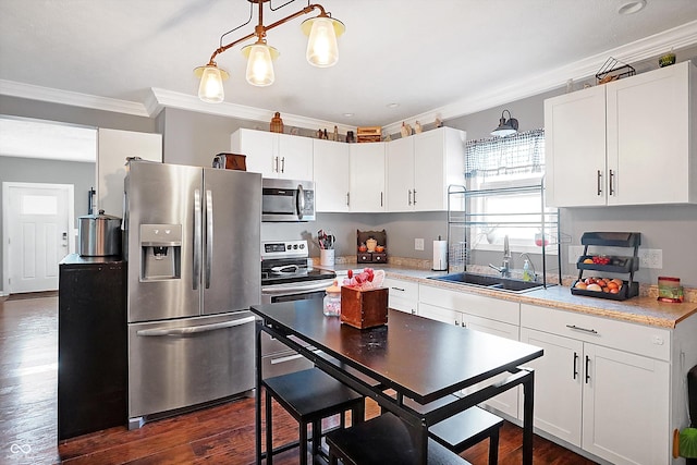 kitchen featuring sink, ornamental molding, white cabinets, and appliances with stainless steel finishes