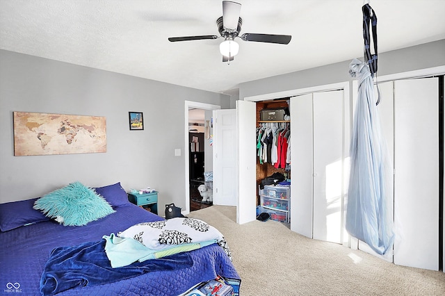 carpeted bedroom featuring ceiling fan and a textured ceiling