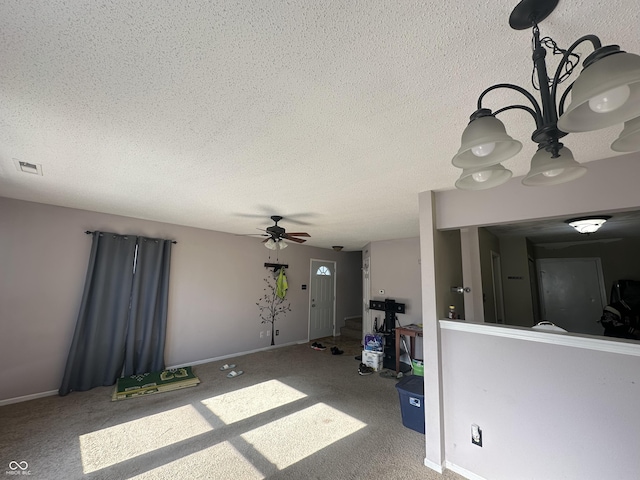 unfurnished living room with a textured ceiling, ceiling fan, and carpet