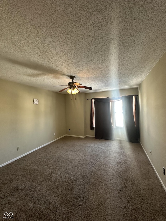 carpeted spare room featuring ceiling fan and a textured ceiling