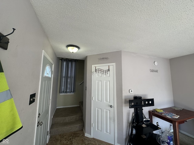 hallway featuring a textured ceiling