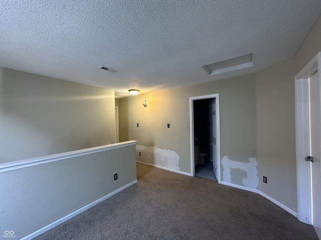 empty room featuring carpet floors and a textured ceiling