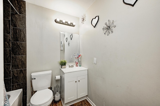 bathroom featuring vanity, toilet, and hardwood / wood-style floors
