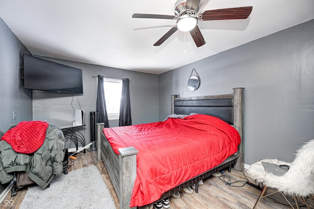 bedroom featuring hardwood / wood-style flooring and ceiling fan