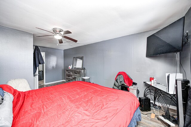 bedroom with ceiling fan and hardwood / wood-style floors