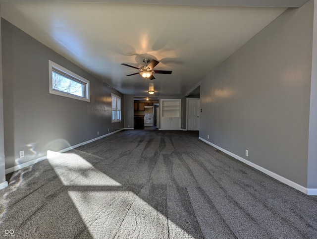 unfurnished living room featuring dark carpet and ceiling fan