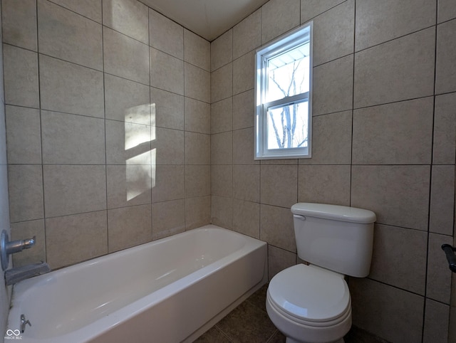 bathroom featuring toilet, shower / bath combination, and tile patterned flooring