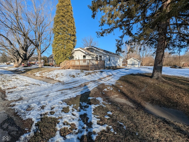 exterior space with an outbuilding, a garage, and a deck