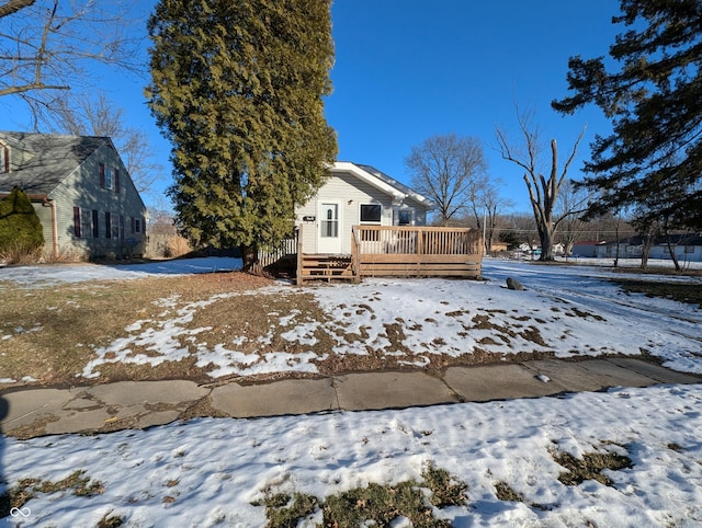 yard covered in snow with a wooden deck