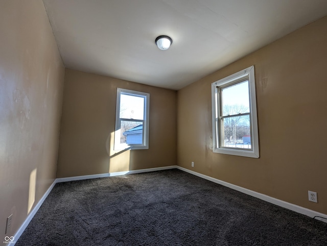 carpeted empty room with a healthy amount of sunlight