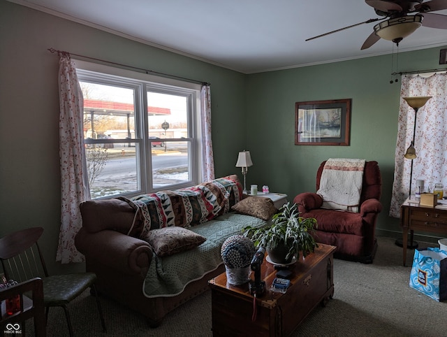 carpeted living room featuring ornamental molding and ceiling fan