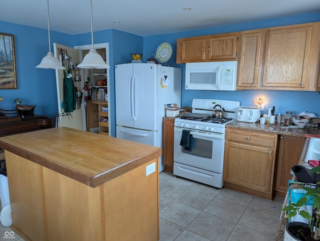 kitchen with pendant lighting, white appliances, light tile patterned flooring, and a kitchen island