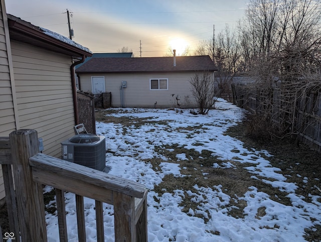 yard layered in snow featuring cooling unit