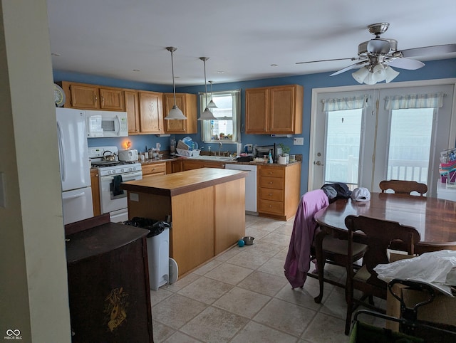 kitchen with ceiling fan, white appliances, hanging light fixtures, and light tile patterned floors