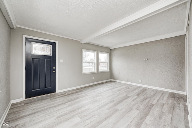 foyer featuring crown molding, a textured ceiling, and light hardwood / wood-style flooring