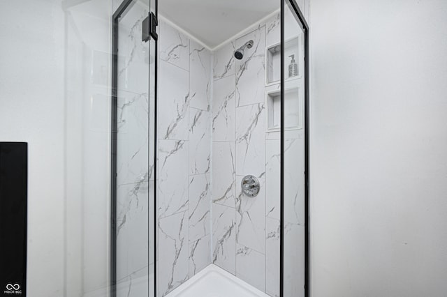 bathroom with tiled shower