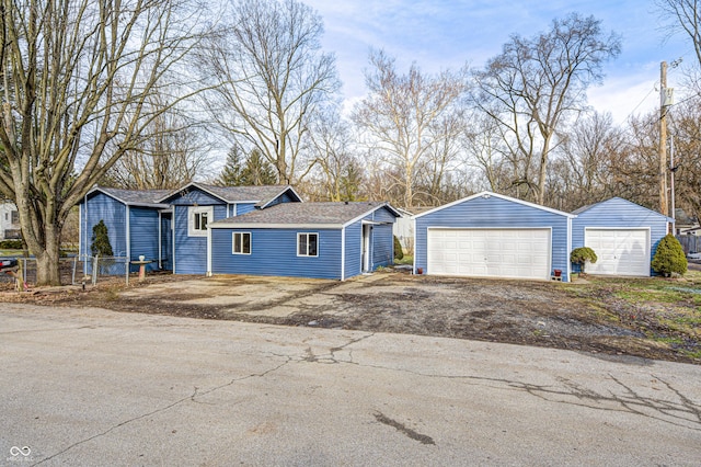 single story home featuring a garage and an outdoor structure