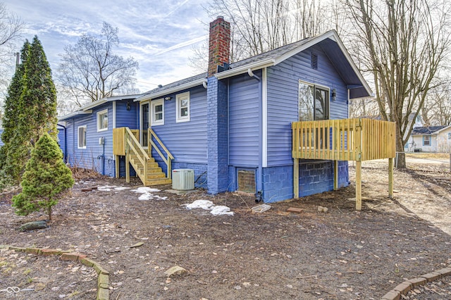 exterior space with a wooden deck and central air condition unit