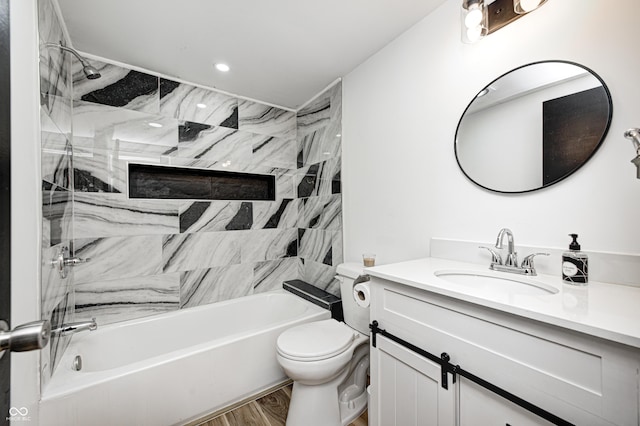 full bathroom with hardwood / wood-style flooring, vanity, toilet, and tiled shower / bath combo