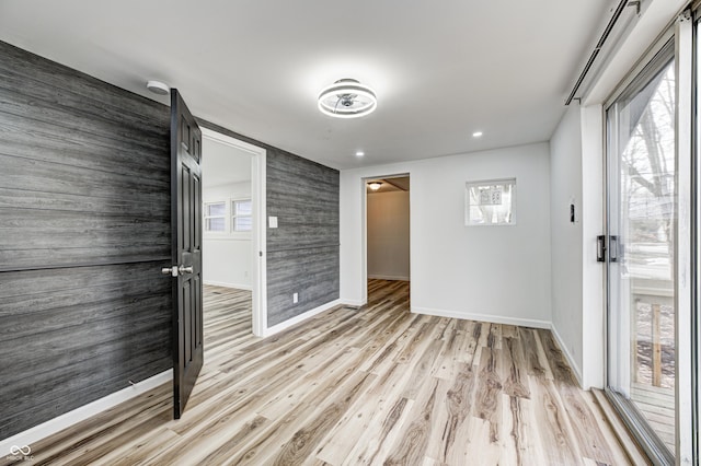 spare room featuring light hardwood / wood-style floors and a healthy amount of sunlight