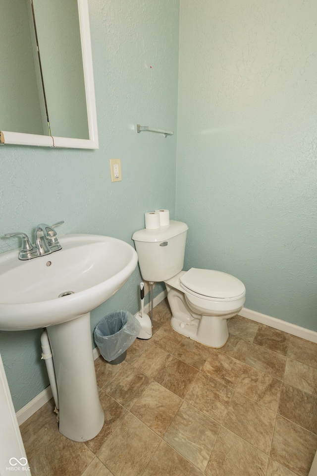 bathroom featuring toilet and sink