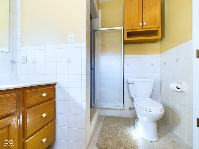 bathroom featuring tile walls, tile patterned flooring, toilet, and walk in shower