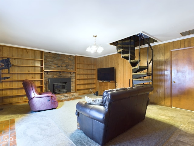 living room featuring crown molding, a notable chandelier, built in shelves, and wood walls